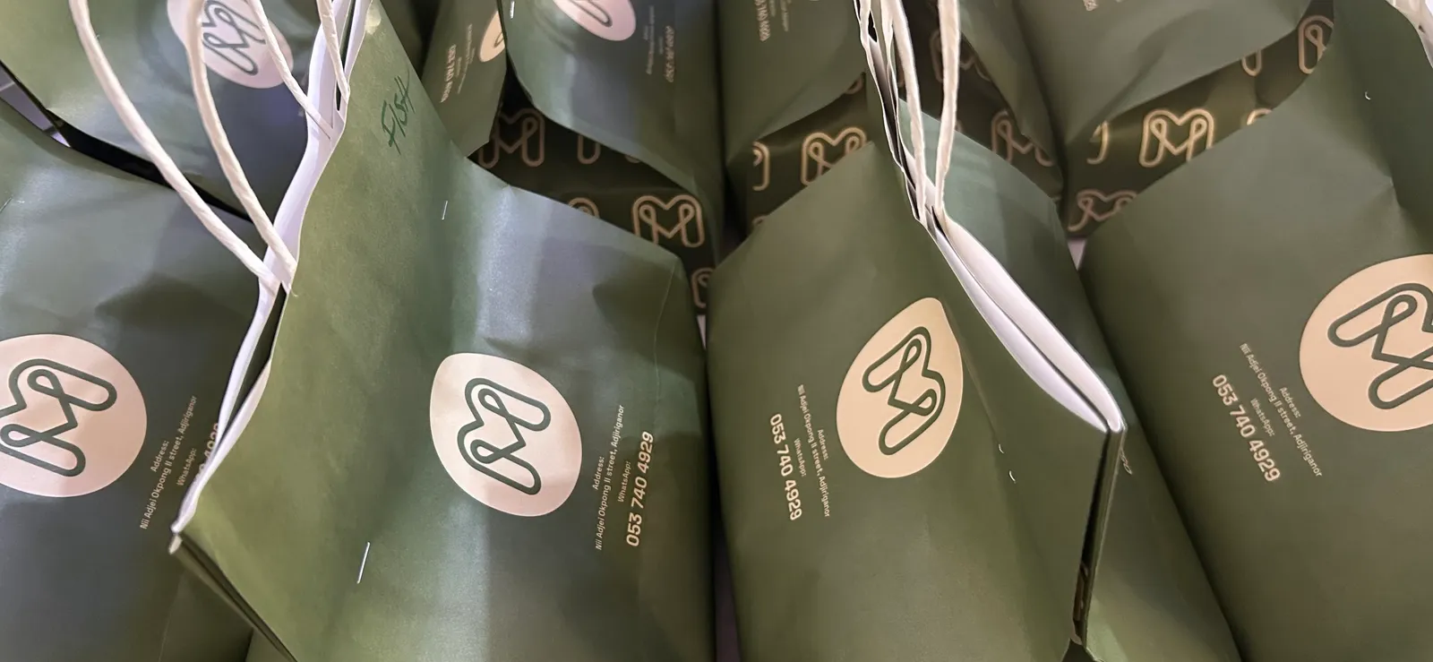 Olive Meal Made takeaway bags with cream emblems