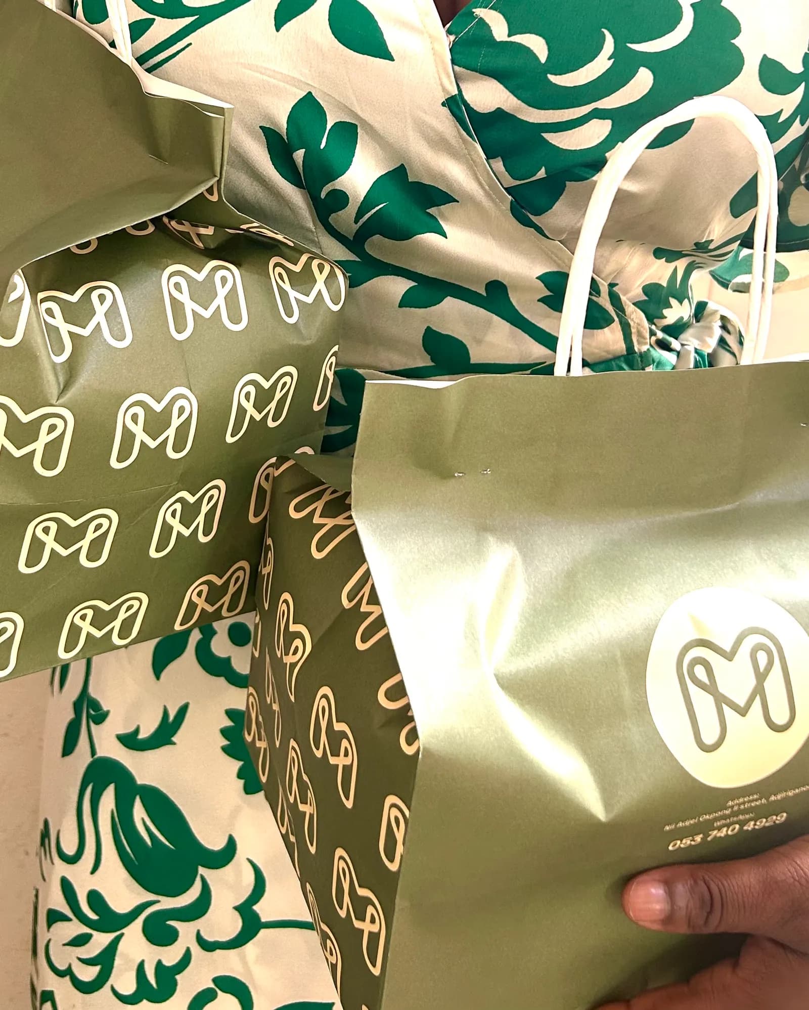 Meal Made's olive and cream takeaway bags with the linked M emblem