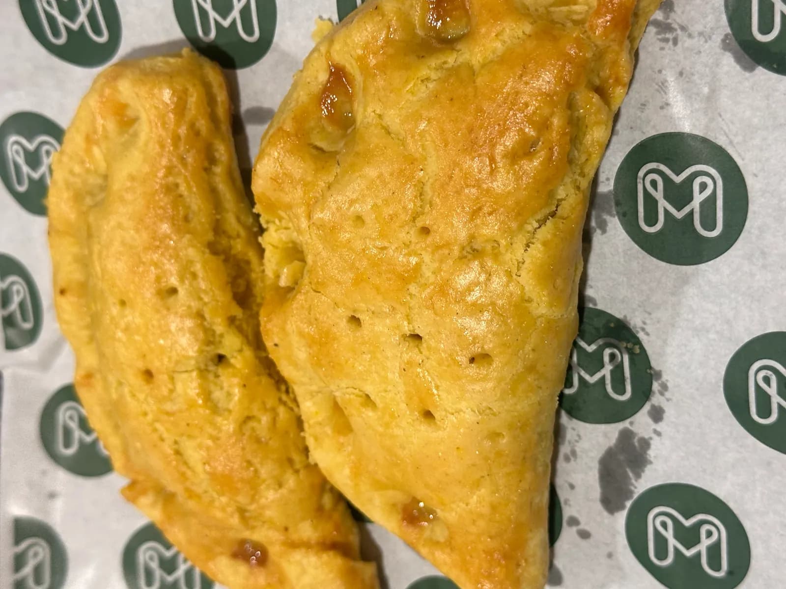 Golden pastries on paper printed with Meal Made's emblem